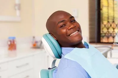 patient smiling after getting dental implants at Derek H. Tang, DDS in Sunnyvale, CA