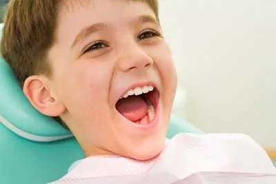 patient laughing during his pediatric dental appointment at Derek H. Tang, DDS